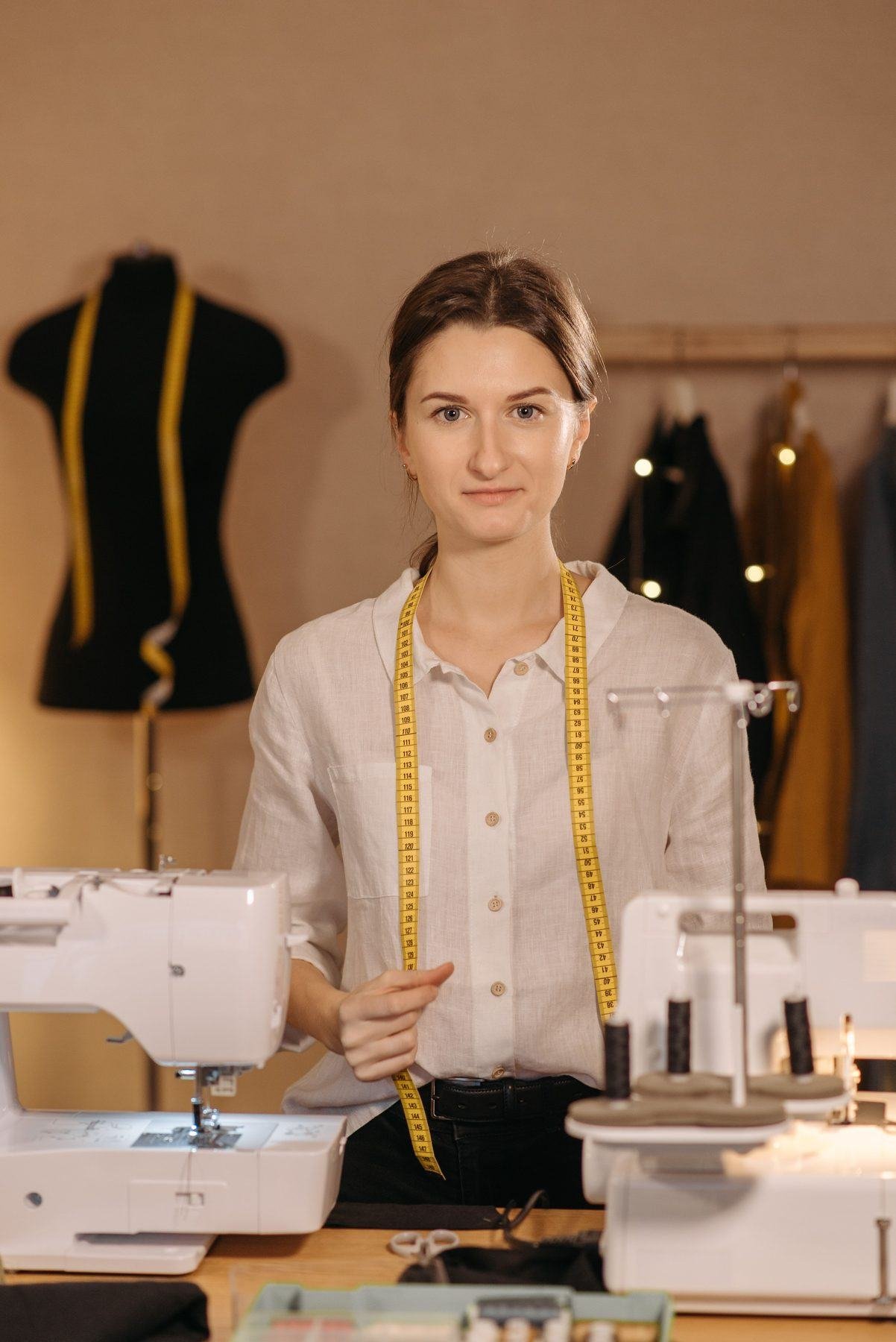 Tailor pinning the seam of a suit jacket on a mannequin